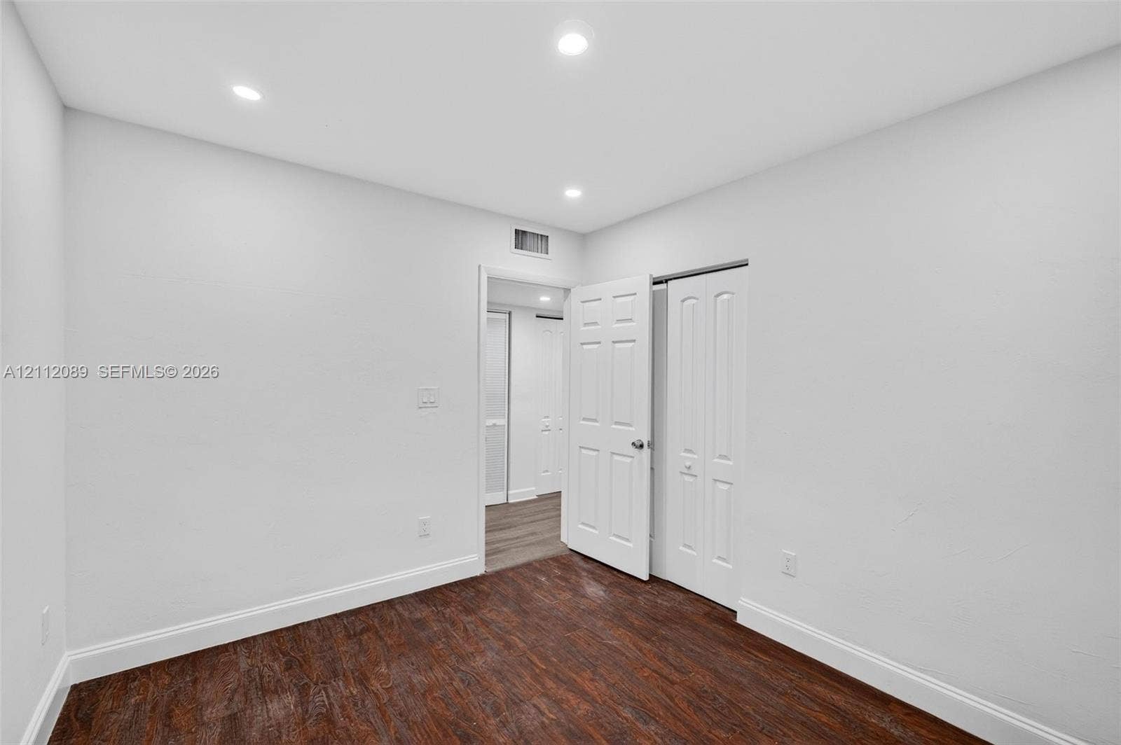 2017 NE 29th Court, Fort Lauderdale, FL 33306 Interior space featuring dark wood-finish flooring, recessed lighting, and white paneled doors