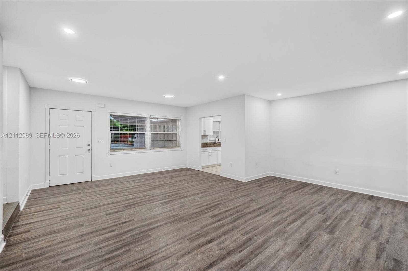 2017 NE 29th Court, Fort Lauderdale, FL 33306 Open-concept room featuring wood-finish flooring, recessed lighting, and a multi-pane window