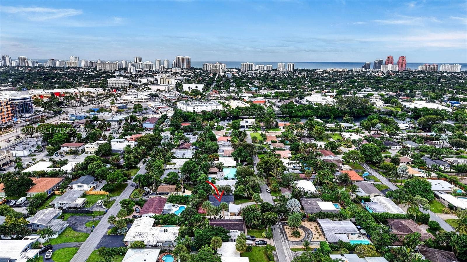 2017 NE 29th Court, Fort Lauderdale, FL 33306 Aerial perspective of the property featuring mature landscaping and a roofline designated by marker, situated within a coastal urban environment