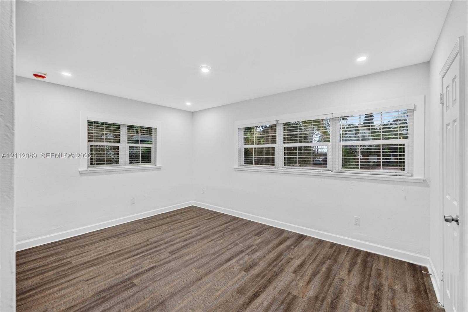 2017 NE 29th Court, Fort Lauderdale, FL 33306 Interior room featuring wood-finish flooring, recessed lighting, and windows with white casings
