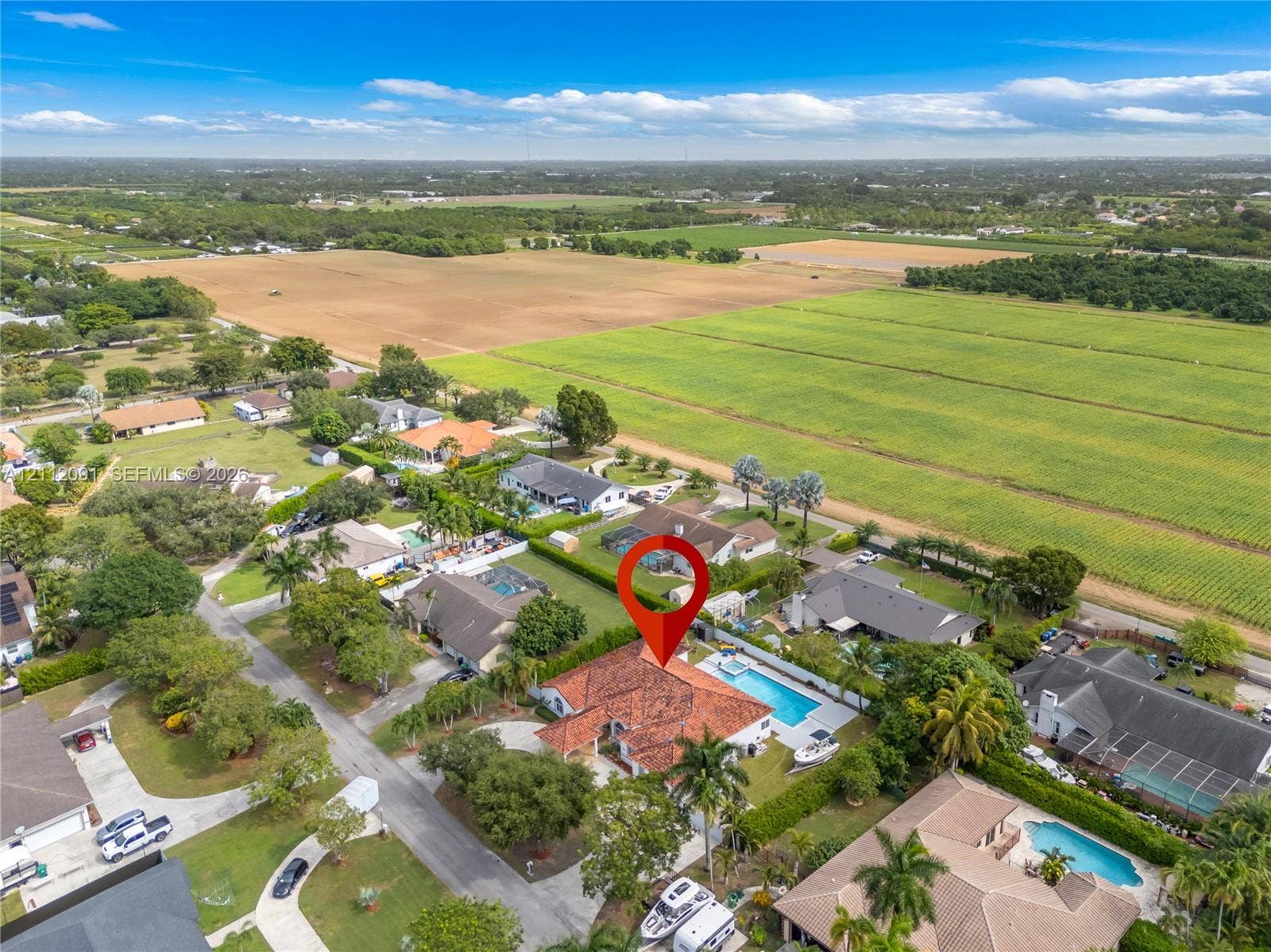 29481 SW 193rd Court, Homestead, FL 33030 Aerial view of residential property featuring a clay tile roof, a private swimming pool, and a paved circular driveway