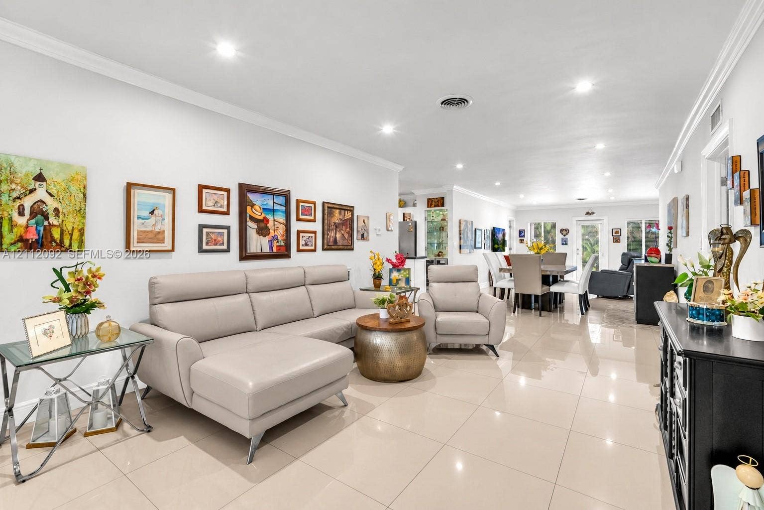 419 Sevilla Avenue, Coral Gables, FL 33134 Open-concept floor plan featuring light-toned tile flooring, recessed lighting, and crown molding