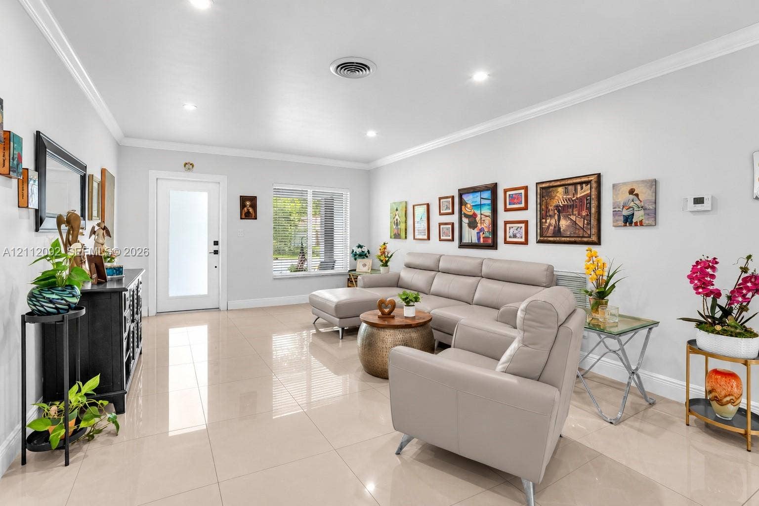 419 Sevilla Avenue, Coral Gables, FL 33134 Neutral-toned polished tile flooring, recessed lighting, crown molding, and a front entry door featuring frosted glass paneling