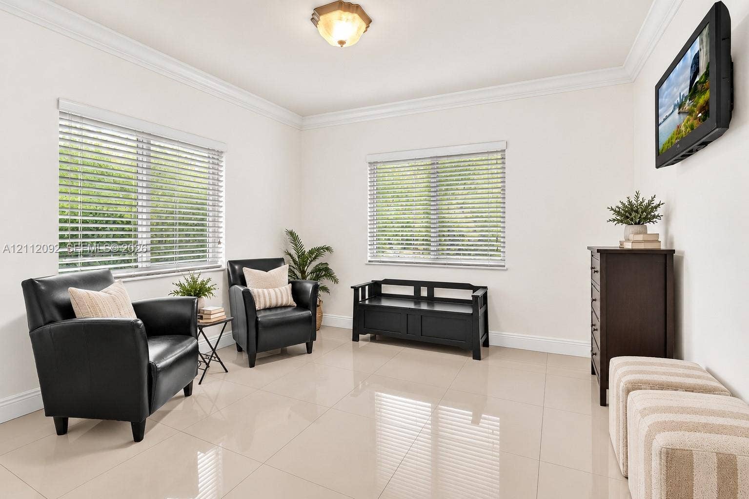 419 Sevilla Avenue, Coral Gables, FL 33134 Neutral-toned tile flooring, dual windows with horizontal blinds, and crown molding