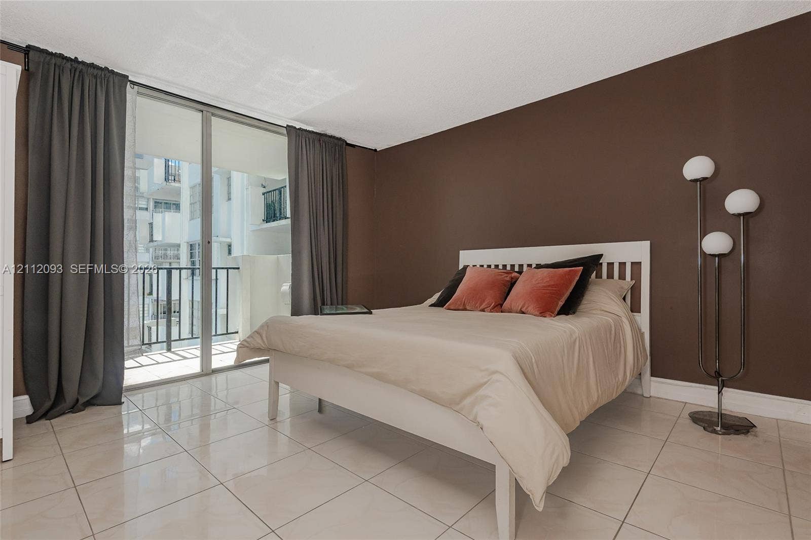 2750 NE 183rd Street, #1612, Aventura, FL 33160 Polished tile flooring and sliding glass doors providing access to a private balcony