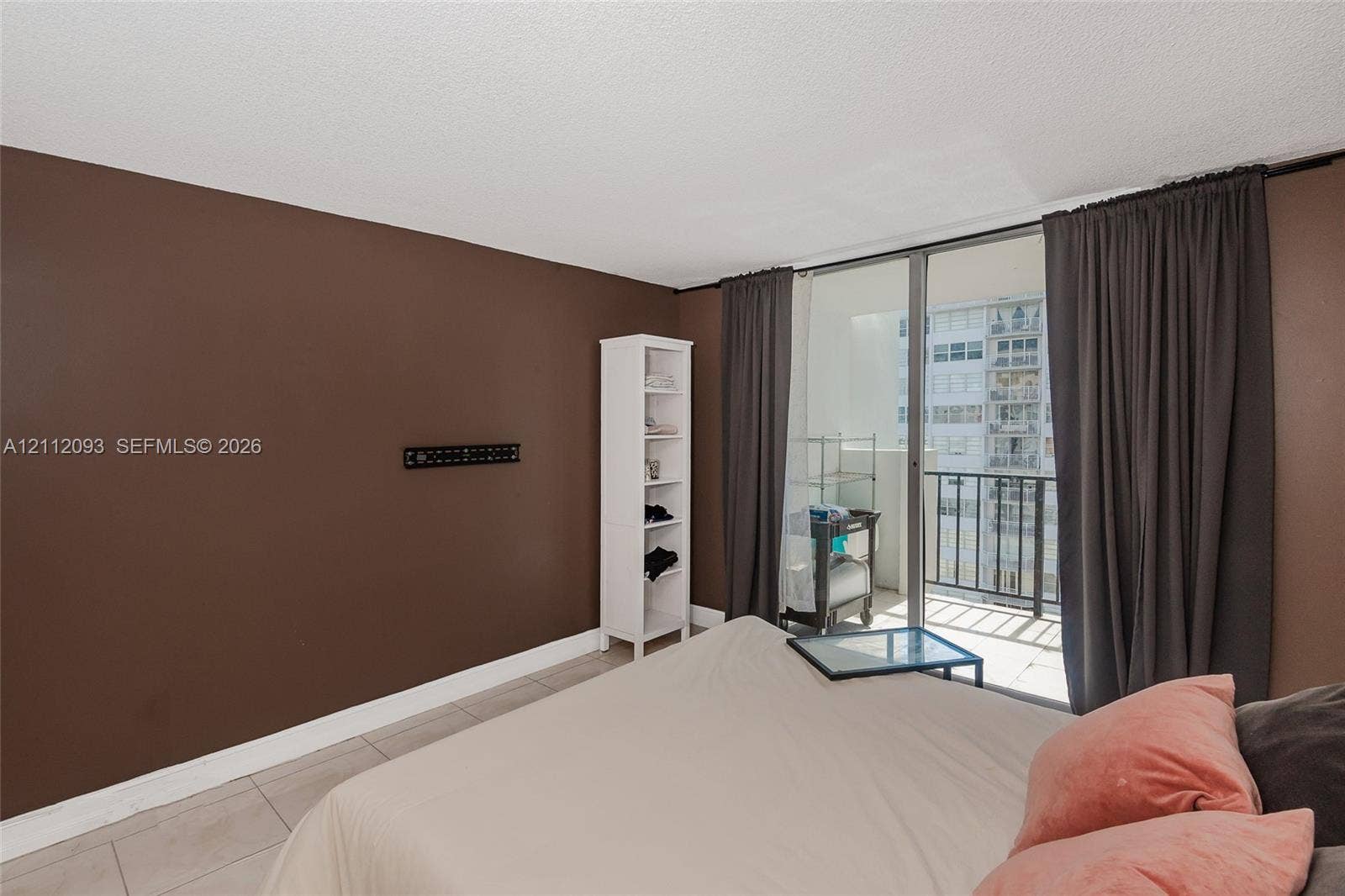 2750 NE 183rd Street, #1612, Aventura, FL 33160 Large-format tile flooring and floor-to-ceiling glass sliding doors providing access to a private balcony with metal railing
