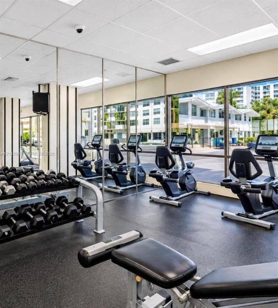 2750 NE 183rd Street, #1612, Aventura, FL 33160 Fitness center featuring wall-to-wall mirrors, floor-to-ceiling windows, and impact-resistant flooring