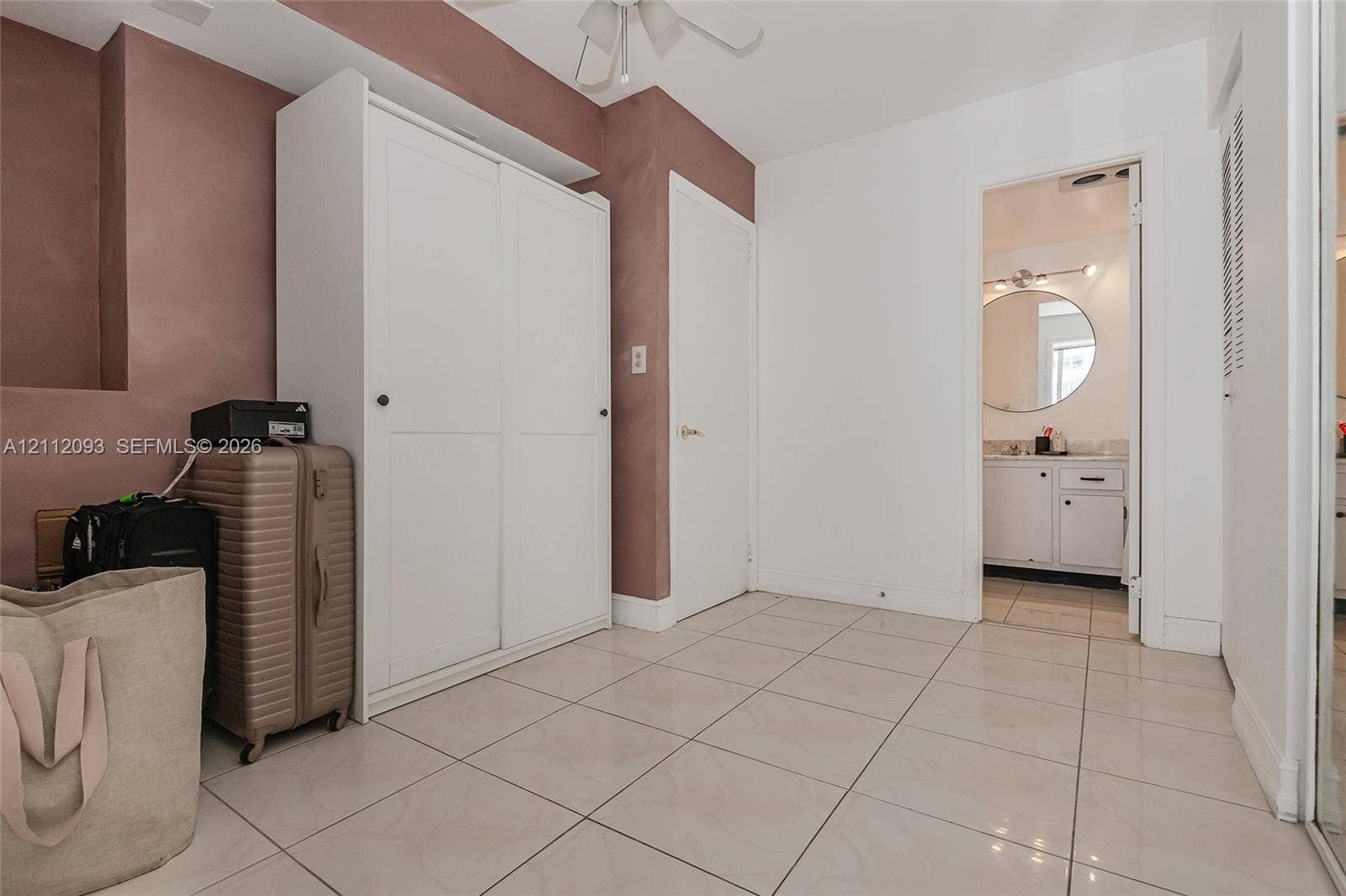 2750 NE 183rd Street, #1612, Aventura, FL 33160 Large-format neutral floor tiling, built-in white wardrobe cabinetry, and recessed ceiling lighting