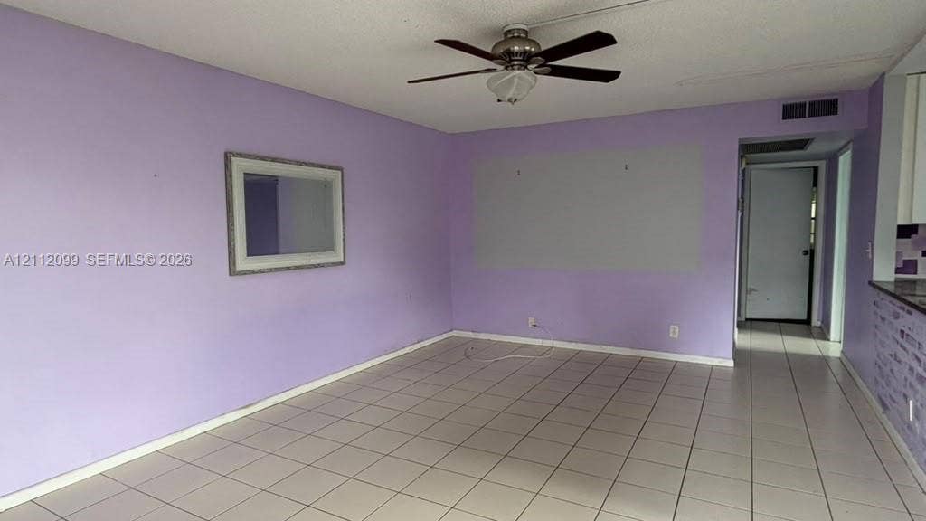 256 Fanshaw G, #2560, Boca Raton, FL 33434 Ceramic tile flooring, ceiling fan with integrated lighting, and wall-mounted interior mirror