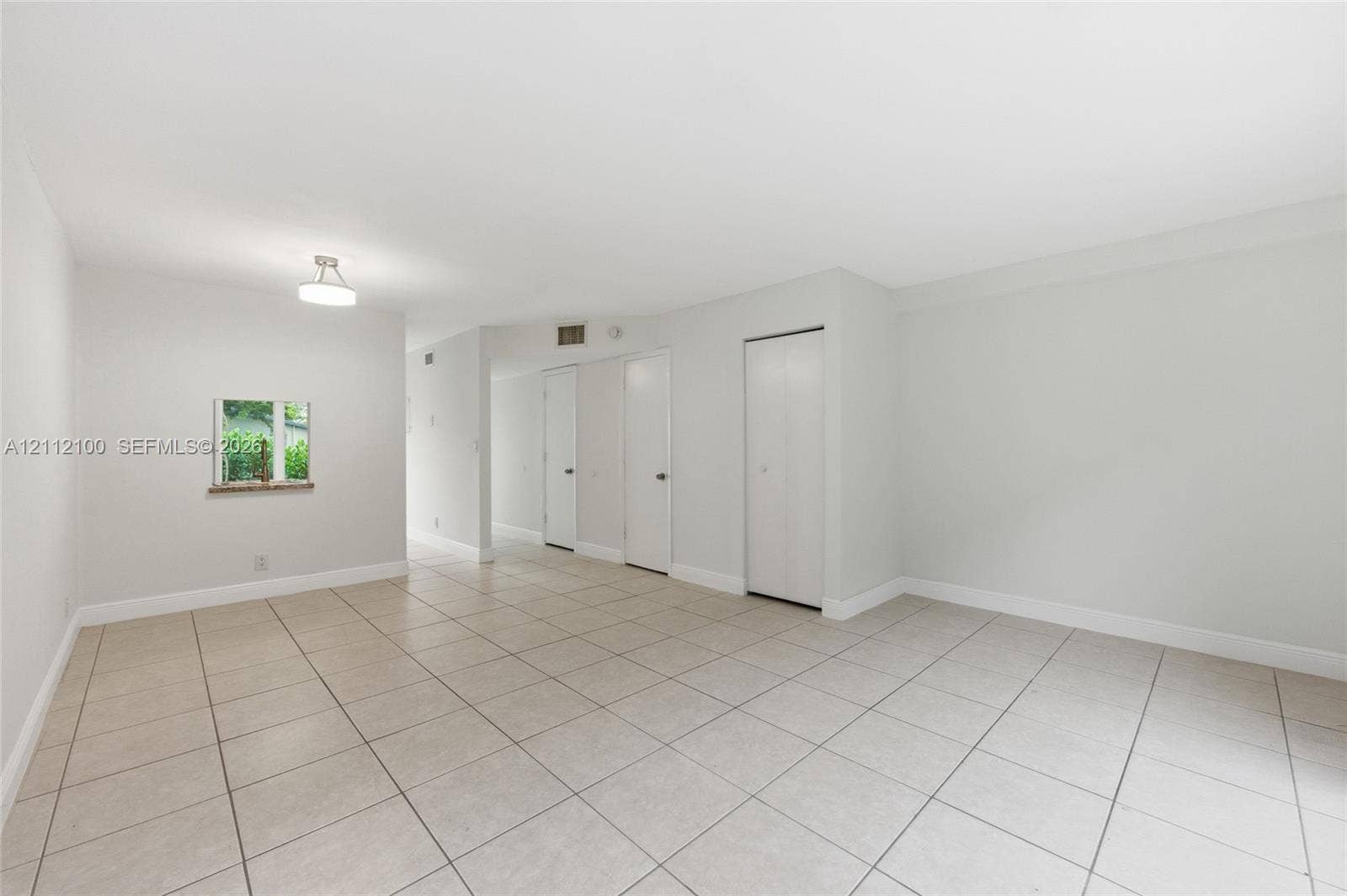 3003 NW 5th Terrace, #1, Pompano Beach, Pompano Beach, FL 33064 Neutral-toned interior featuring ceramic tile flooring, recessed ceiling lighting, and multiple interior closet doors