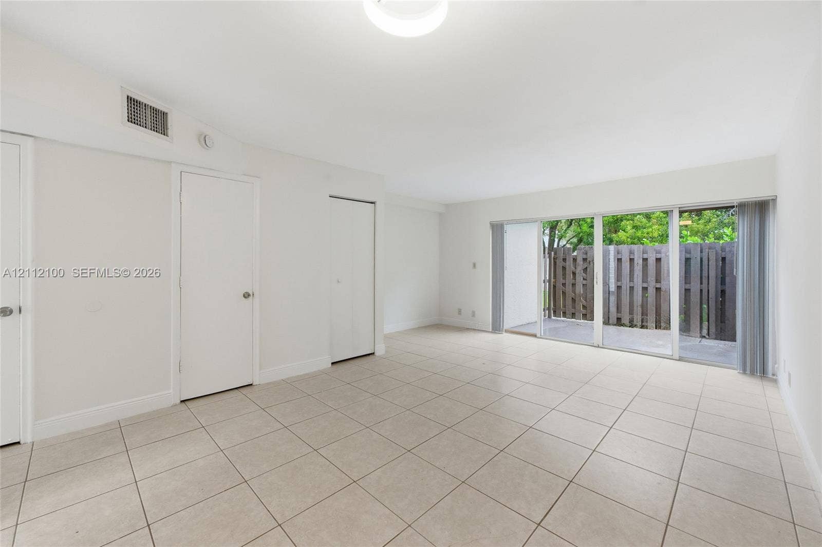 3003 NW 5th Terrace, #1, Pompano Beach, Pompano Beach, FL 33064 Neutral-toned ceramic tile flooring, sliding glass doors, and solid-core interior doors