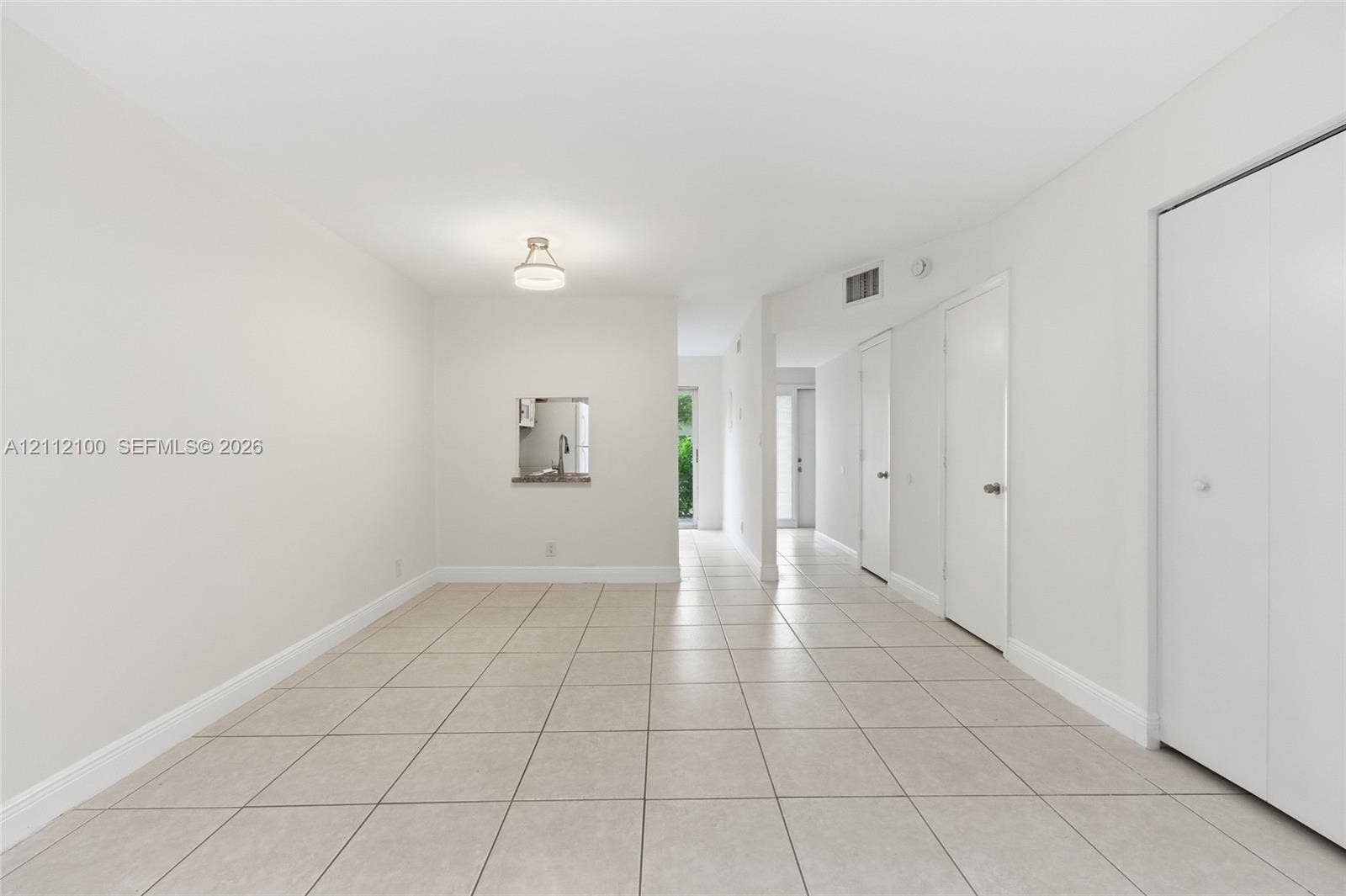 3003 NW 5th Terrace, #1, Pompano Beach, Pompano Beach, FL 33064 Neutral-toned tile flooring, recessed pass-through window, and minimalist flush-mount lighting