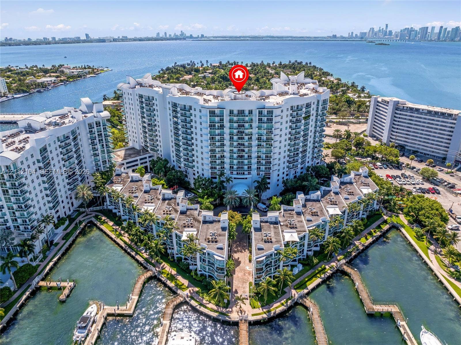 7900 Harbor Island Drive, #1203, North Bay Village, North Bay Village, FL 33141 Aerial perspective of a waterfront residential complex featuring multiple deep-water boat slips, manicured tropical landscaping, and structural balconies overlooking the bay