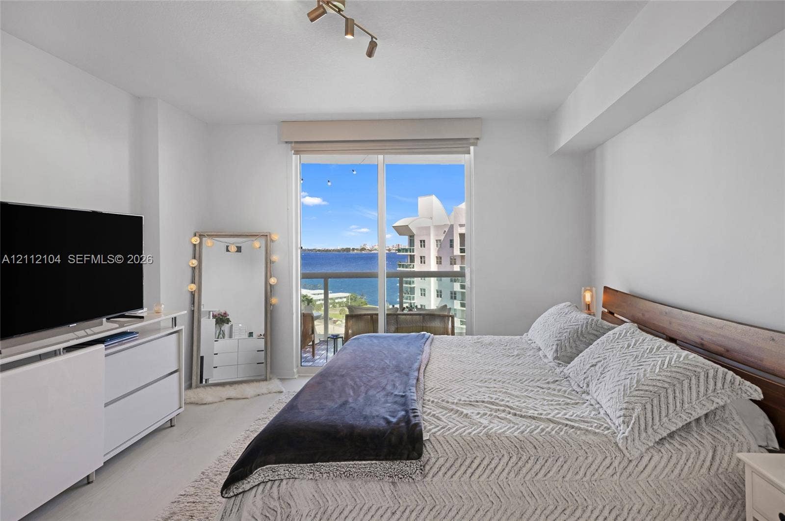 7900 Harbor Island Drive, #1203, North Bay Village, North Bay Village, FL 33141 Sliding glass door with integrated window treatment, multi-light ceiling-mounted fixture, and water-facing balcony