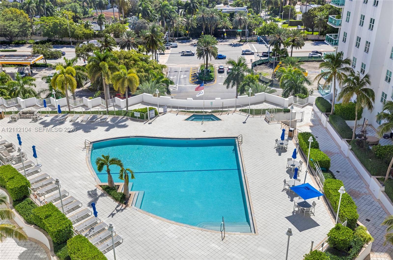 7900 Harbor Island Drive, #1203, North Bay Village, North Bay Village, FL 33141 Swimming pool with integrated spa, surrounded by expansive paved decking and manicured privacy hedging