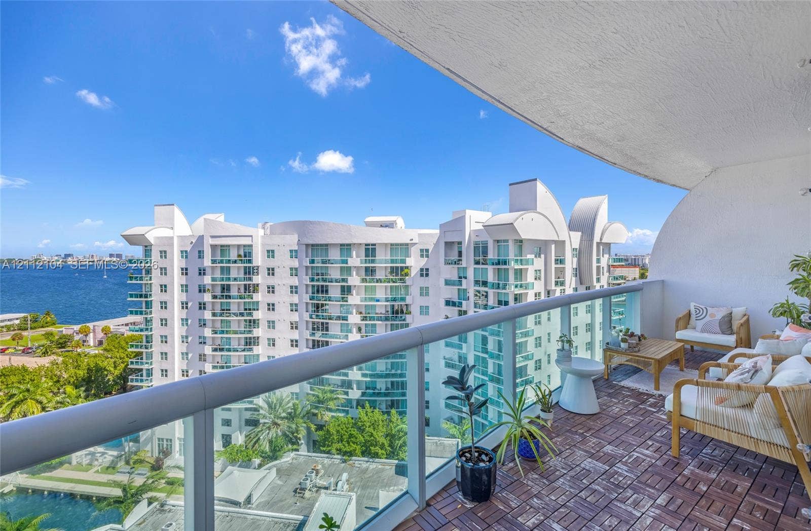 7900 Harbor Island Drive, #1203, North Bay Village, North Bay Village, FL 33141 Covered balcony featuring modular wood-tile flooring and glass panel railing
