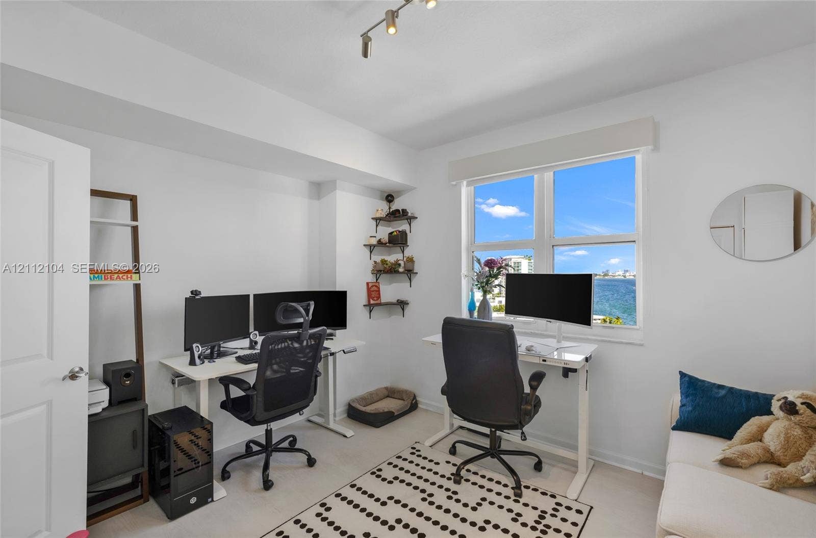 7900 Harbor Island Drive, #1203, North Bay Village, North Bay Village, FL 33141 Room featuring a window with water backdrop, neutral wall tones, and overhead track lighting