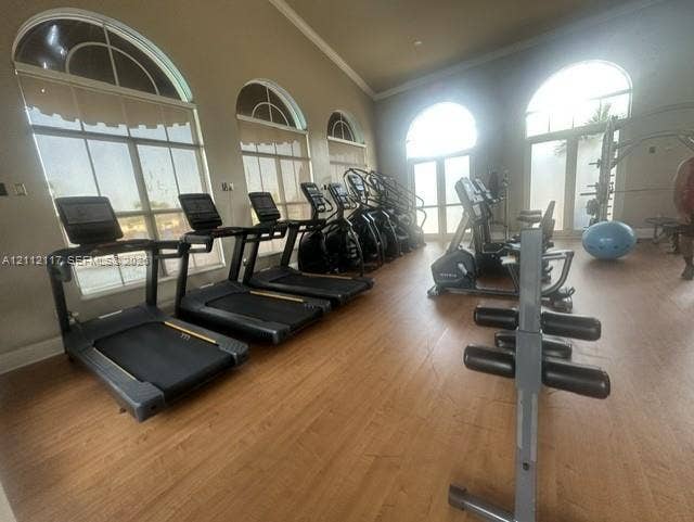 1209 NE 32nd Avenue, Homestead, Homestead, FL 33033 Fitness room featuring wood-finish flooring, vaulted ceilings, and arched windows