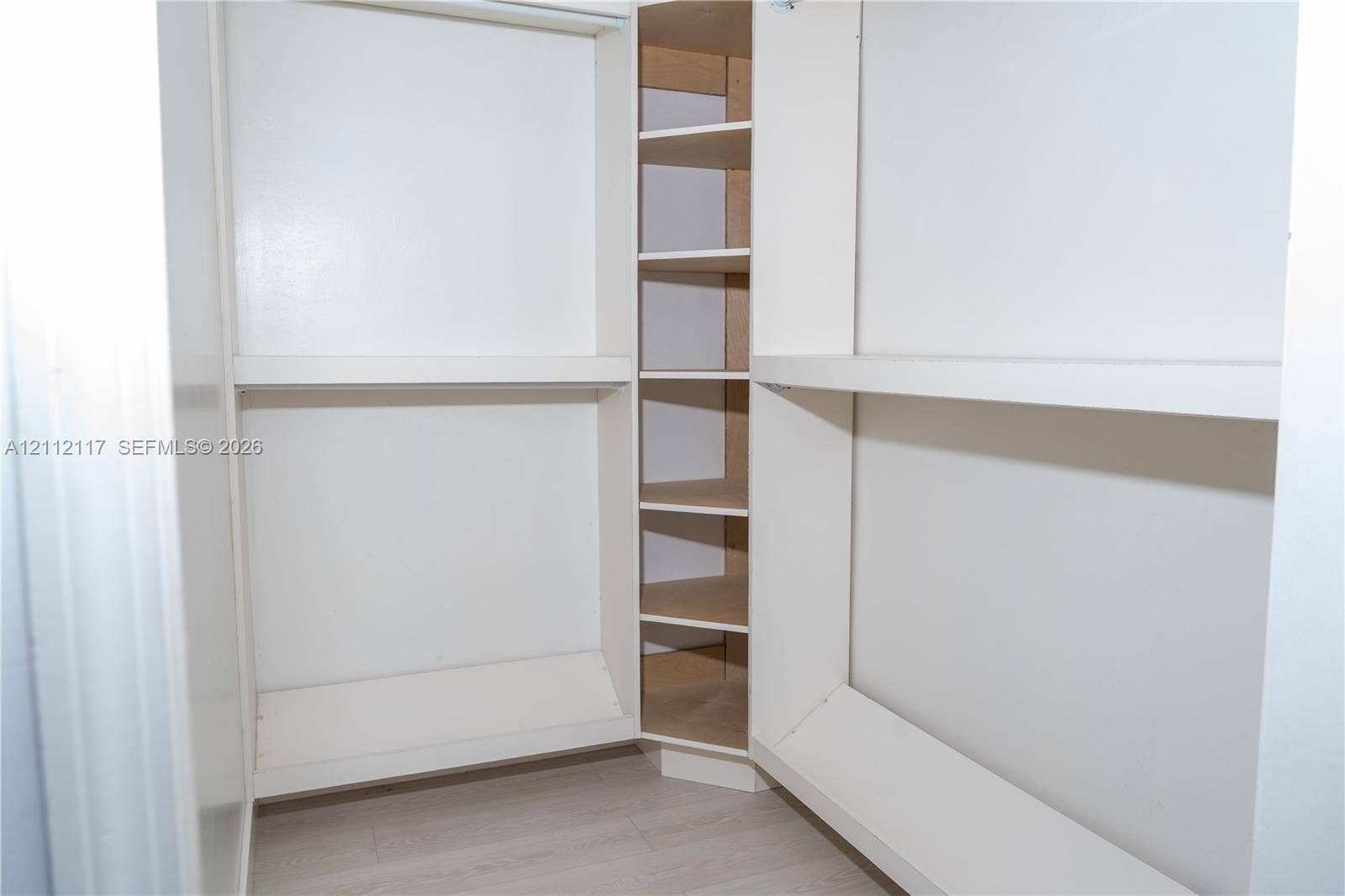 1209 NE 32nd Avenue, Homestead, Homestead, FL 33033 Storage area featuring white built-in shelving and wood-finish flooring