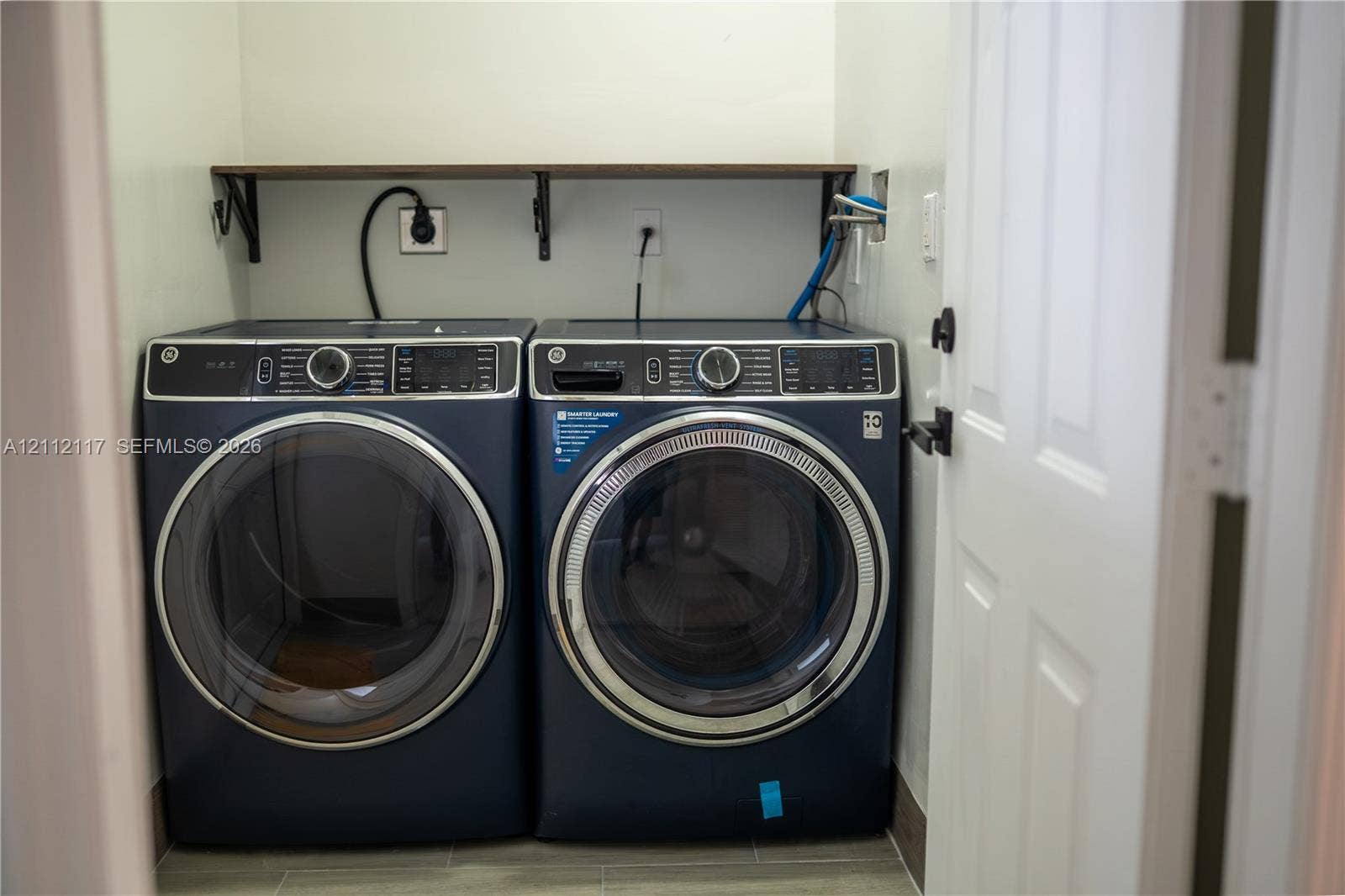 1209 NE 32nd Avenue, Homestead, Homestead, FL 33033 Laundry area featuring a wall-mounted shelf and tile flooring