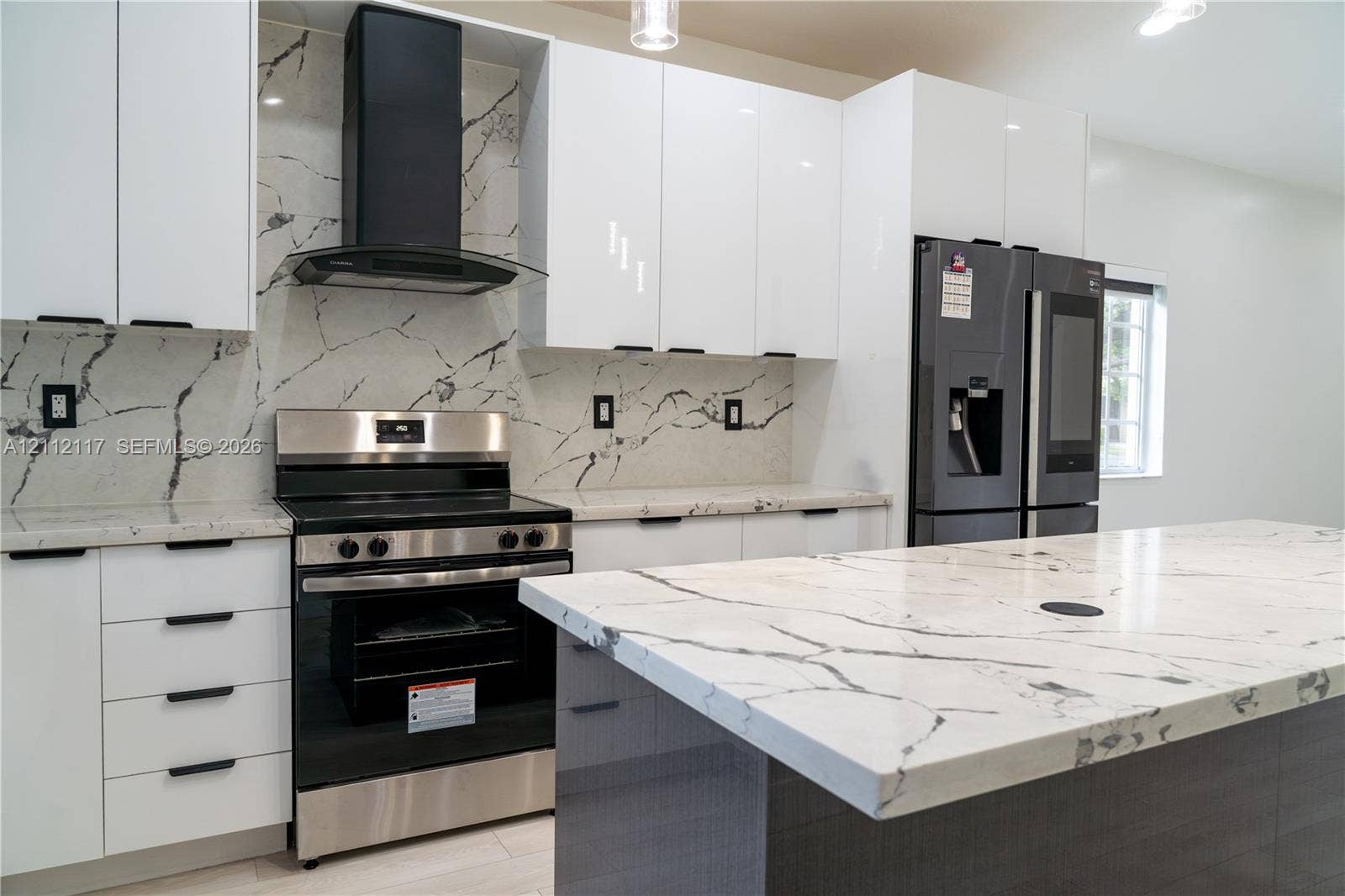 1209 NE 32nd Avenue, Homestead, Homestead, FL 33033 Kitchen featuring high-gloss white cabinetry, stone-patterned countertops, matching full-height backsplash, stainless steel range with a wall-mounted chimney hood, and a central island with integrated stone surfacing