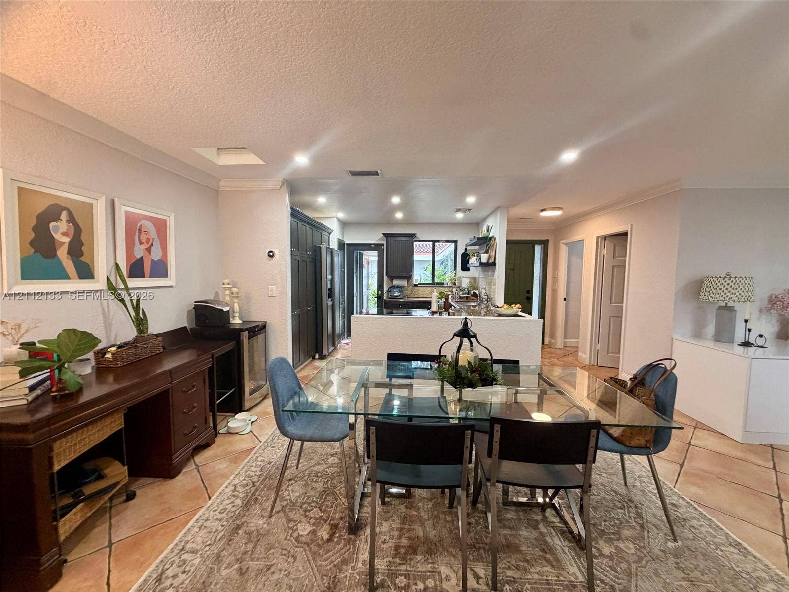 407 Bonnie Brae Way, #22, Hollywood, Hollywood, FL 33021 Open-concept kitchen area featuring large-format diagonal tile flooring, recessed ceiling lighting, a white kitchen island, and dark-toned cabinetry