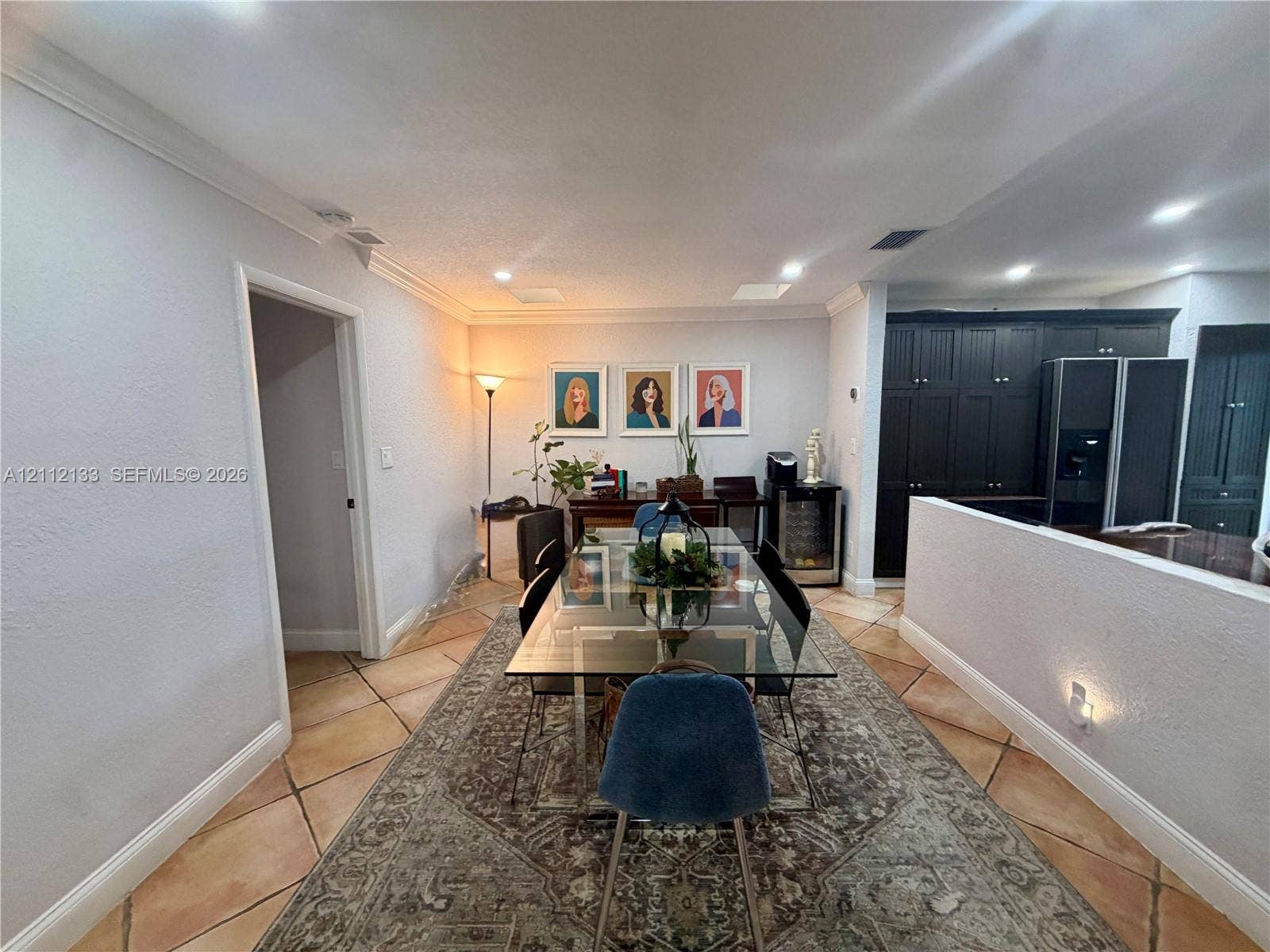 407 Bonnie Brae Way, #22, Hollywood, Hollywood, FL 33021 Neutral-tone walls with crown molding, square tile flooring, recessed lighting, and dark-finish built-in cabinetry