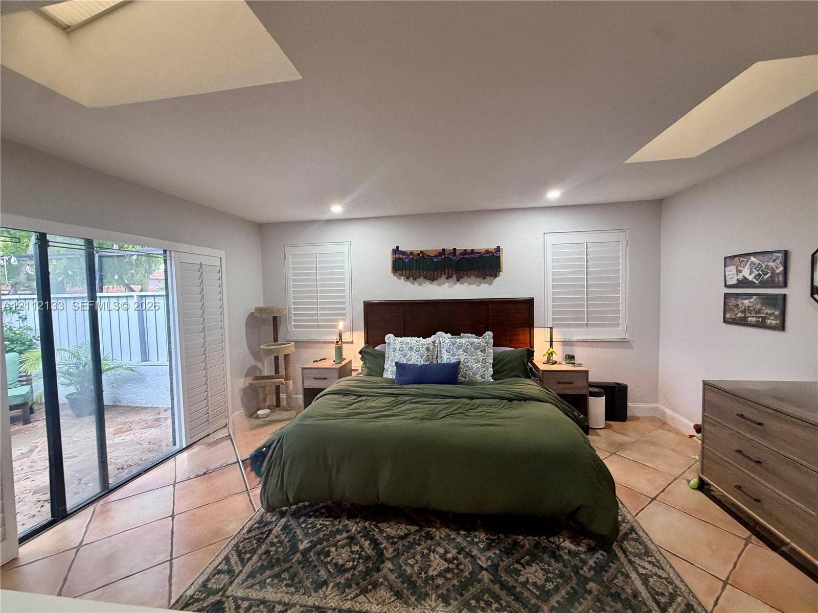 407 Bonnie Brae Way, #22, Hollywood, Hollywood, FL 33021 Spacious room featuring vaulted ceilings with dual skylights, large sliding glass doors, tile flooring, and plantation shutters