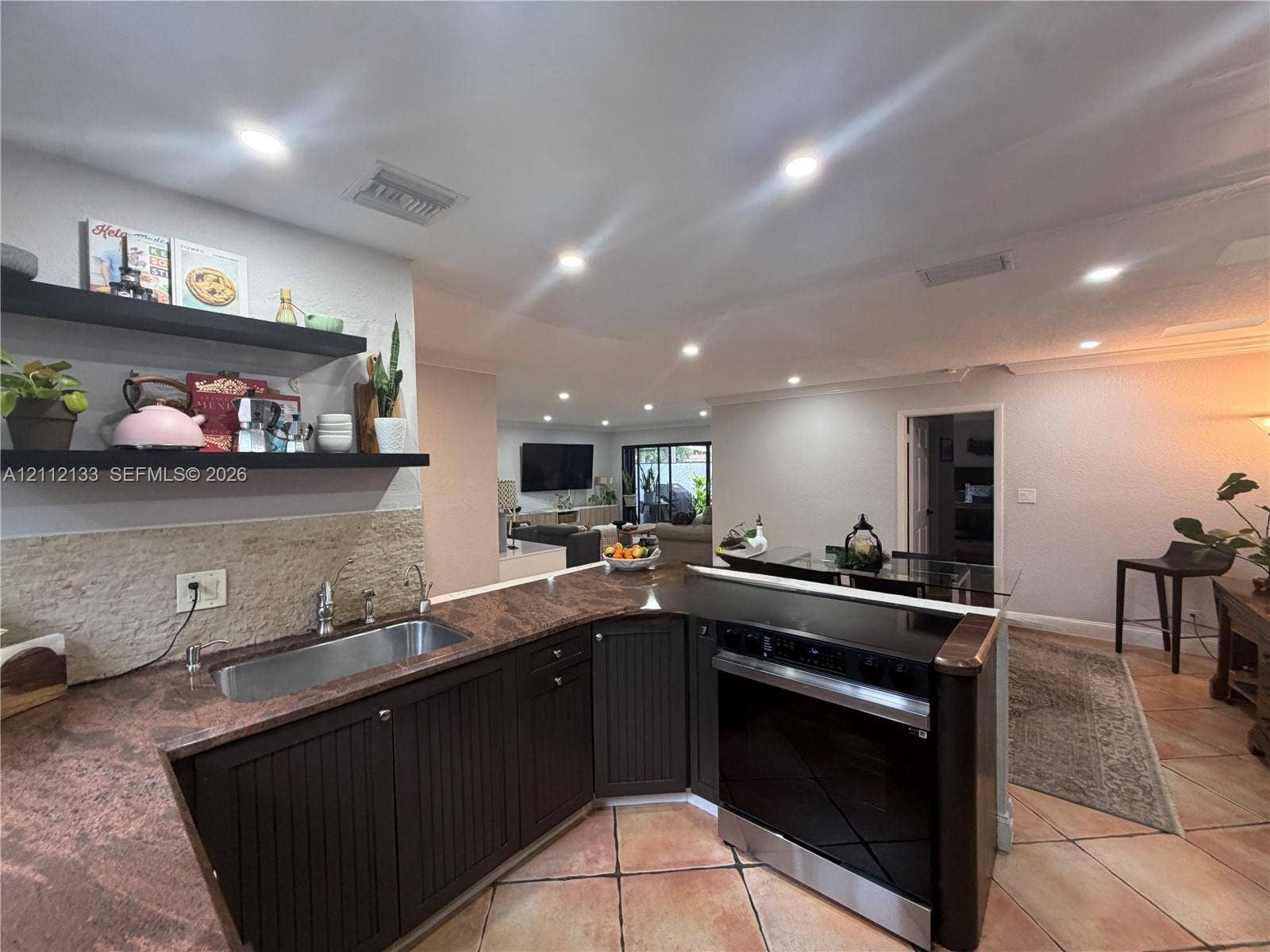 407 Bonnie Brae Way, #22, Hollywood, Hollywood, FL 33021 Kitchen featuring dark cabinetry, stone-finish countertops, an undermount stainless steel sink, built-in recessed lighting, and wall-mounted shelving