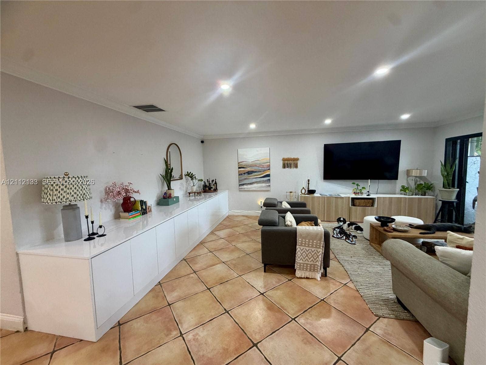 407 Bonnie Brae Way, #22, Hollywood, Hollywood, FL 33021 Open-concept interior featuring large-format diagonal tile flooring, extensive built-in white cabinetry with a sleek finish, recessed ceiling lighting, and wood-toned media storage cabinetry
