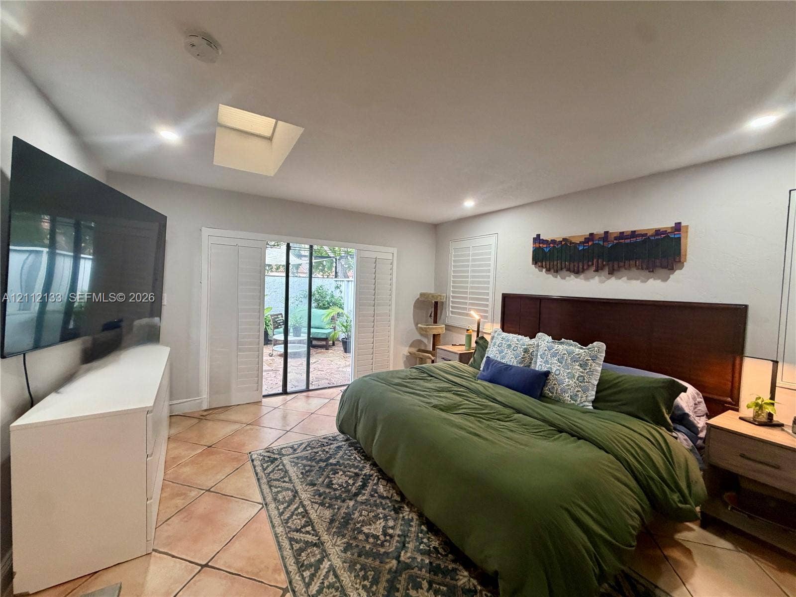 407 Bonnie Brae Way, #22, Hollywood, Hollywood, FL 33021 Room featuring tile flooring, a built-in skylight, sliding glass patio doors with white plantation shutters, and recessed lighting