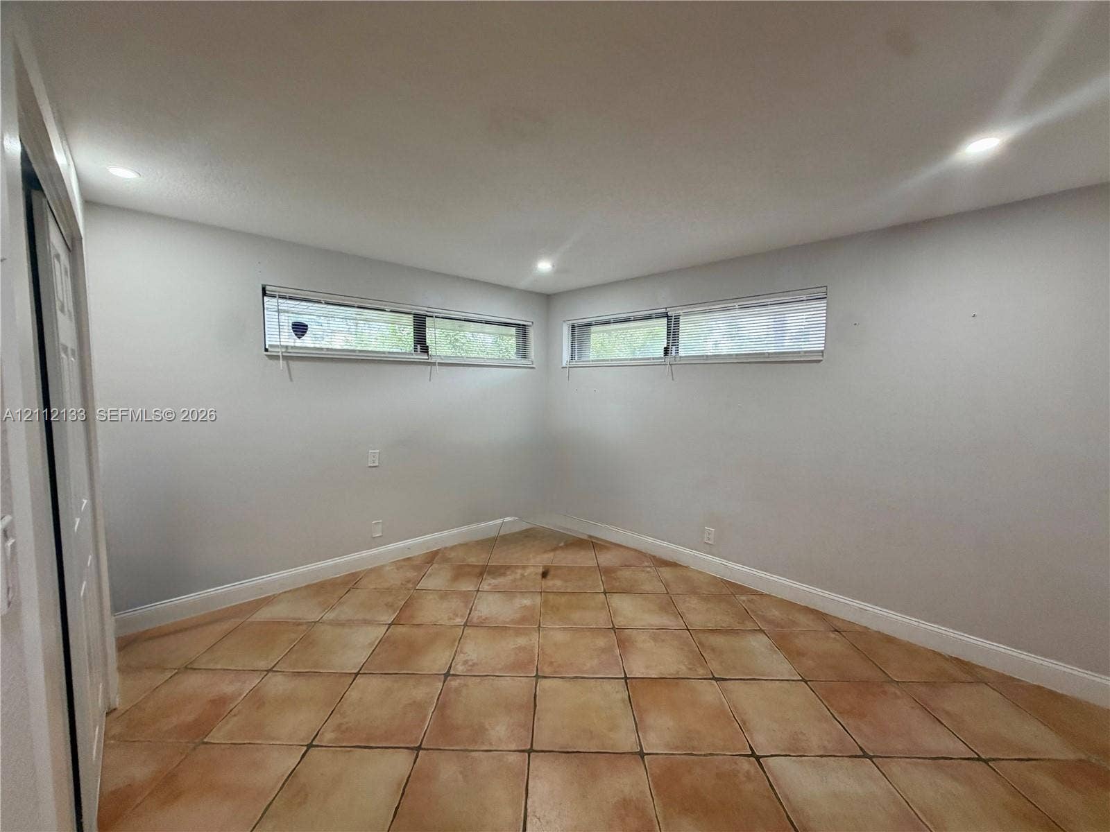 407 Bonnie Brae Way, #22, Hollywood, Hollywood, FL 33021 Interior space featuring neutral wall paint, tile flooring, two horizontal sliding windows, and recessed lighting