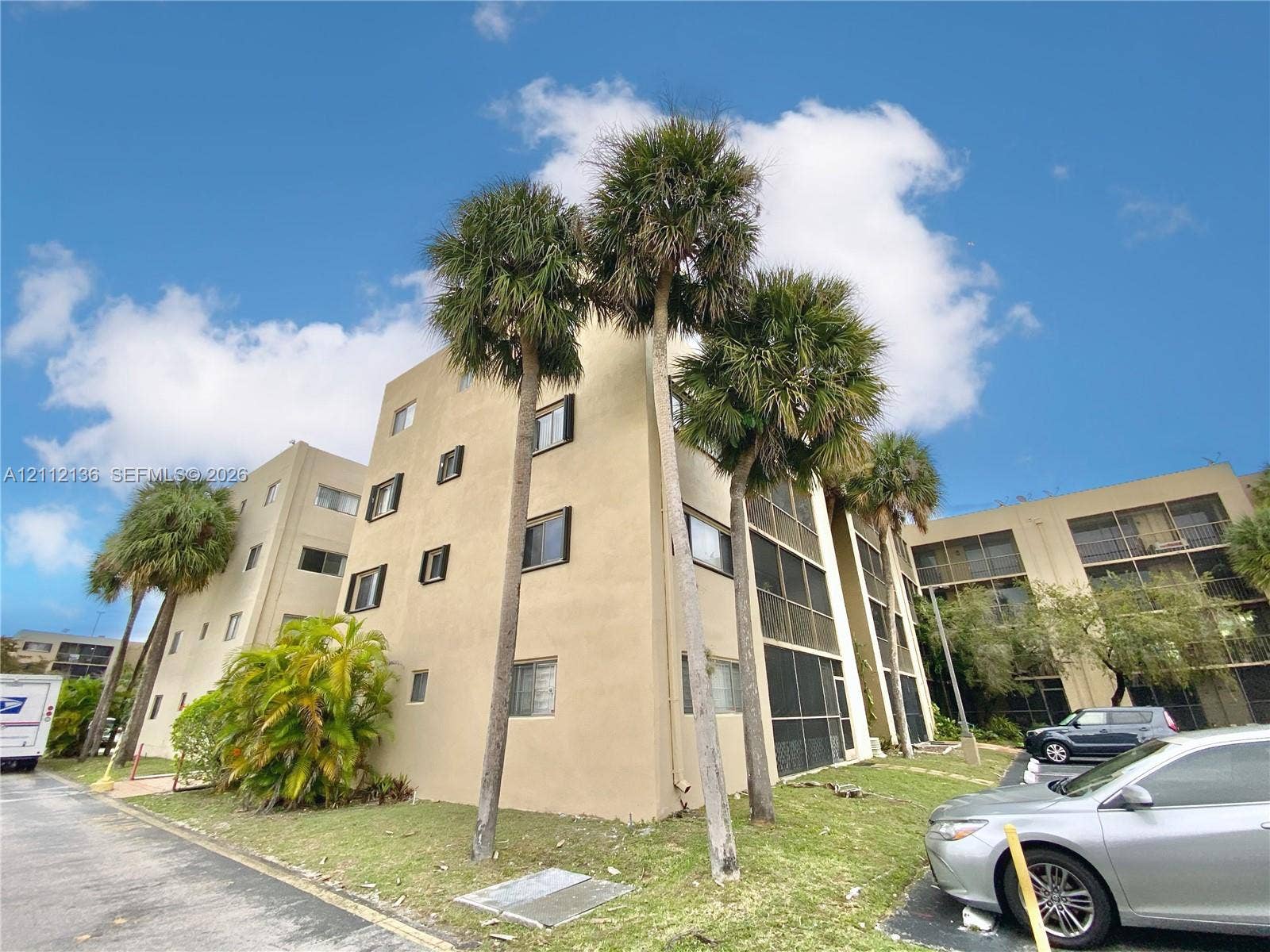 8635 NW 8th Street, #109, Miami, Miami, FL 33126 Multi-story stucco exterior featuring screened lanais and mature palm trees