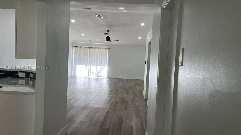 Interior featuring wood-finish flooring, recessed lighting, a ceiling fan, and sliding glass doors