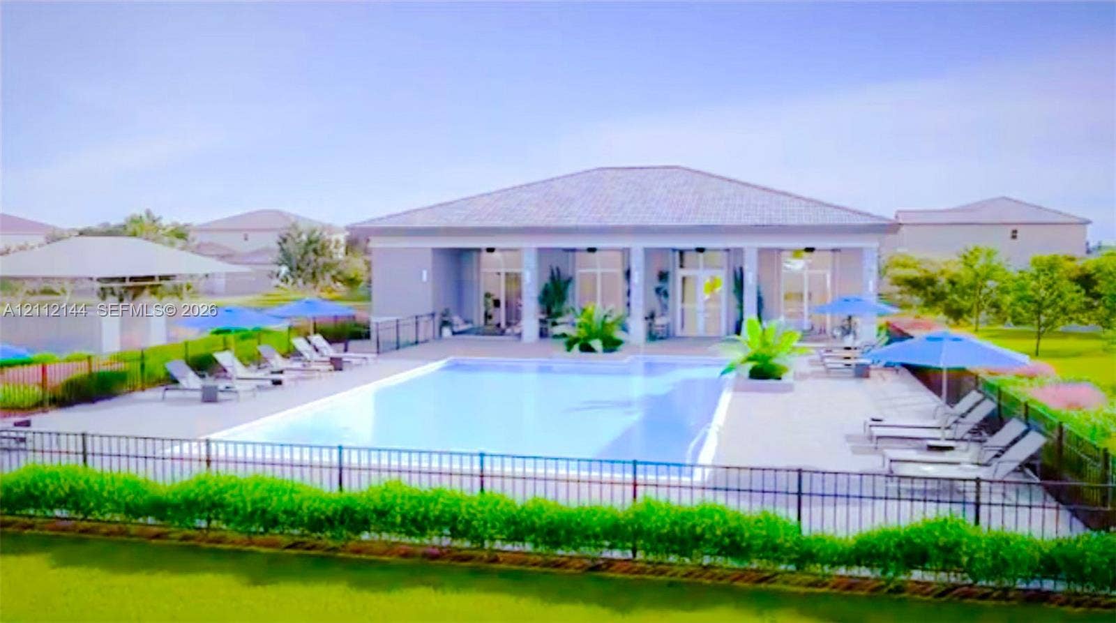 29216 SW 163rd Court, #29216, Homestead, Homestead, FL 33033 Swimming pool with a surrounding paved deck, covered patio, metal perimeter fencing, and manicured landscaping