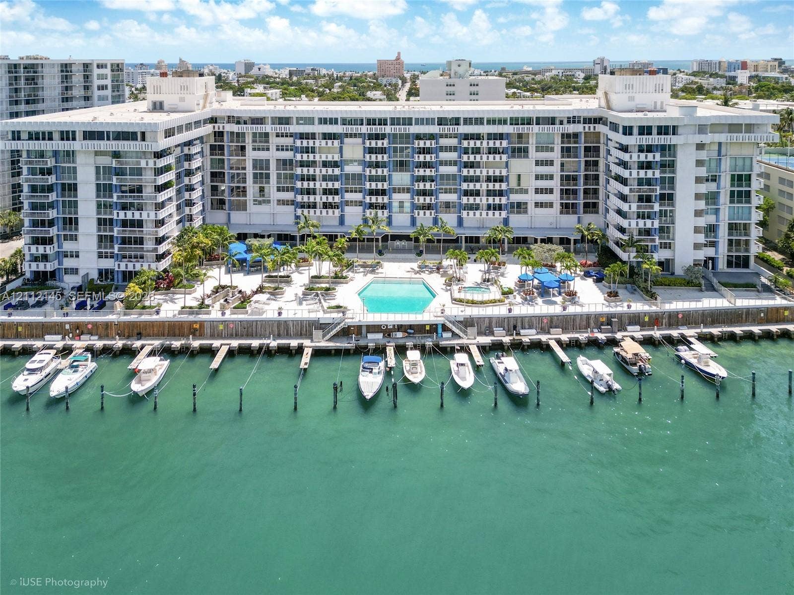800 West Avenue, #PH-37, Miami Beach, FL 33139 Waterfront multi-story residential building featuring a private deep-water dock, integrated swimming pool, spa, and exterior balcony access for residential units