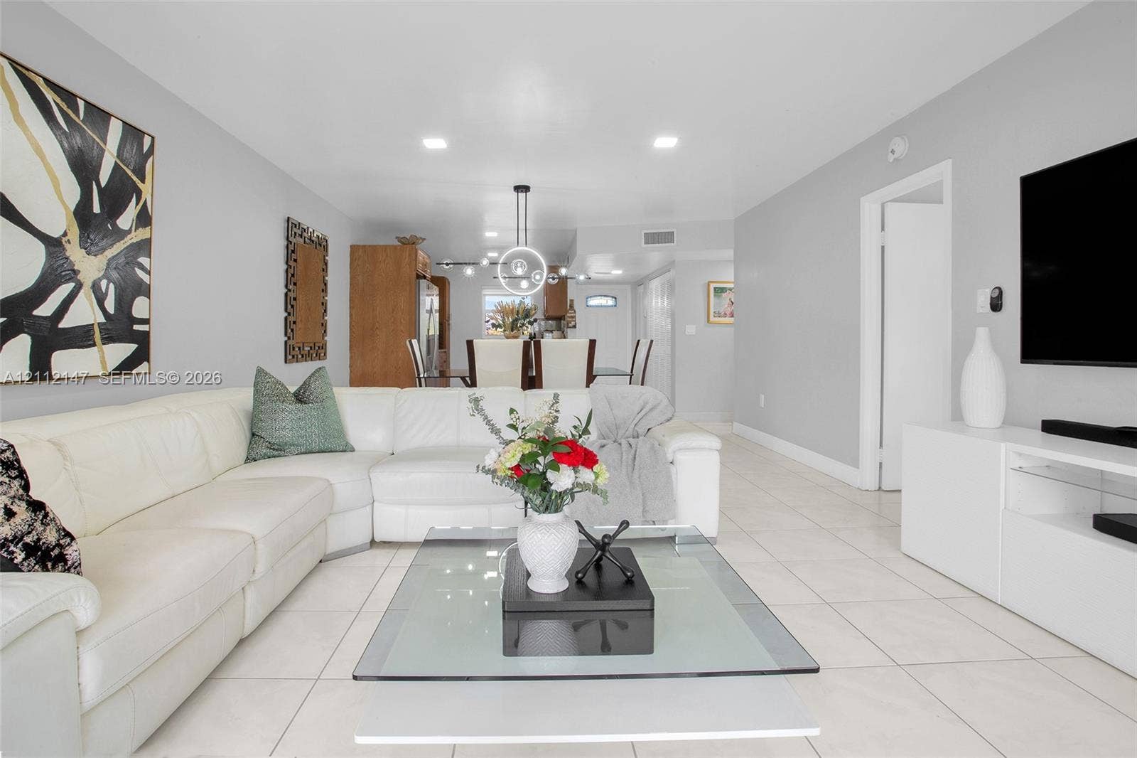 8331 Sands Point Boulevard, #C308, Tamarac, FL 33321 Large format tile flooring, recessed lighting, and contemporary ring chandelier