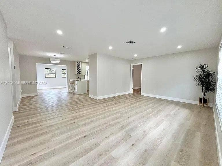 1753 N 16th Court N, Lake Worth, Lake Worth, FL 33460 Open interior featuring wood-finish flooring, recessed lighting, and kitchen cabinetry with built-in wine storage