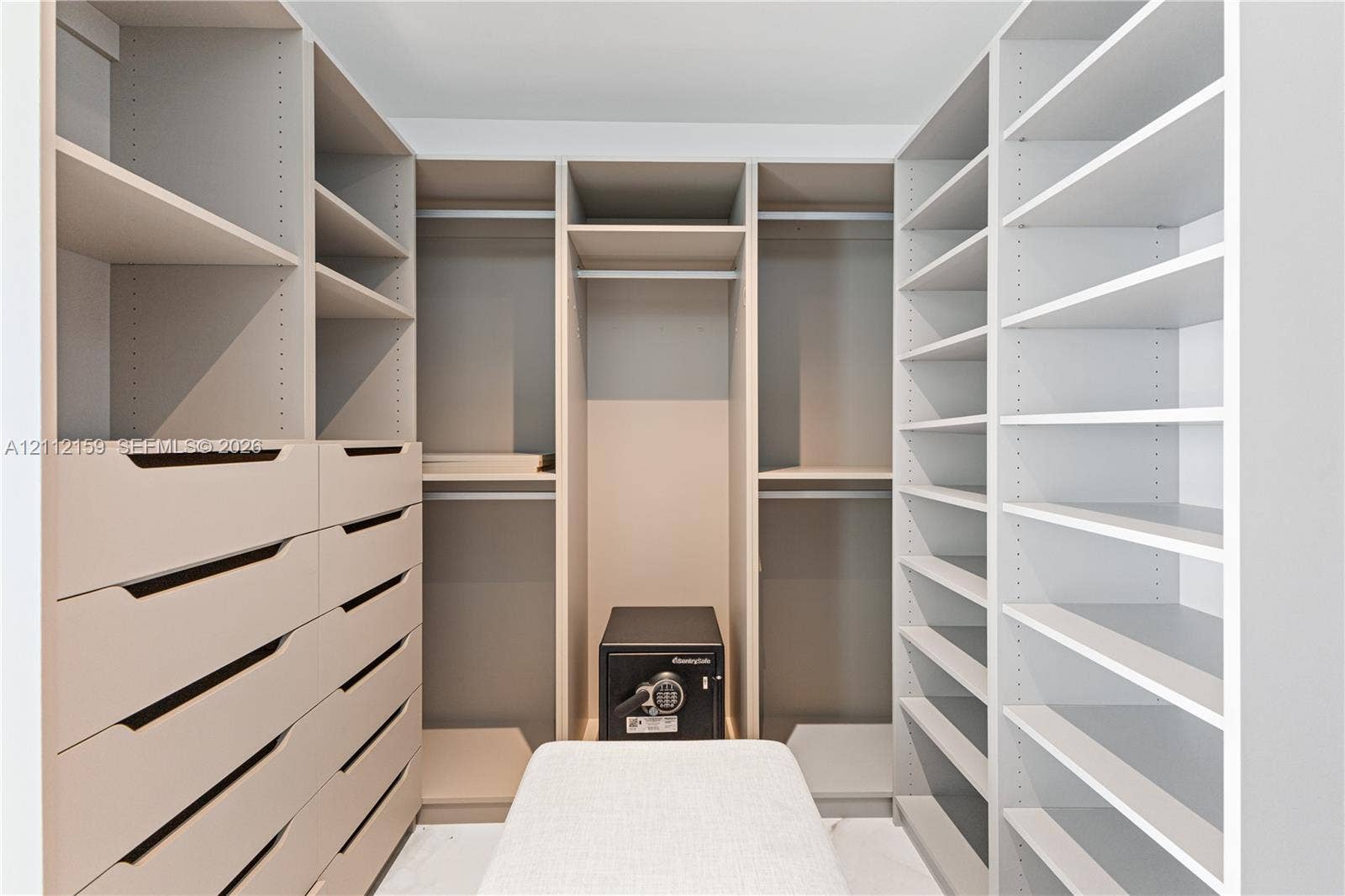 18975 Collins Avenue, #802, Sunny Isles Beach, Sunny Isles Beach, FL 33160 Custom walk-in closet featuring extensive built-in shelving, multiple hanging rods, and integrated storage drawers with cutout handles