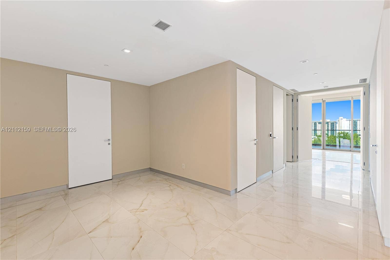 18975 Collins Avenue, #802, Sunny Isles Beach, Sunny Isles Beach, FL 33160 Polished stone flooring with veining, recessed lighting, smooth-finish ceilings, and floor-to-ceiling glass panel doors