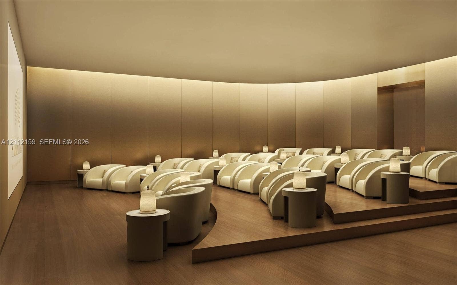 18975 Collins Avenue, #802, Sunny Isles Beach, Sunny Isles Beach, FL 33160 Curved room featuring wood-finish flooring, tiered platform seating, integrated cove lighting, and floor-to-ceiling metallic wall paneling