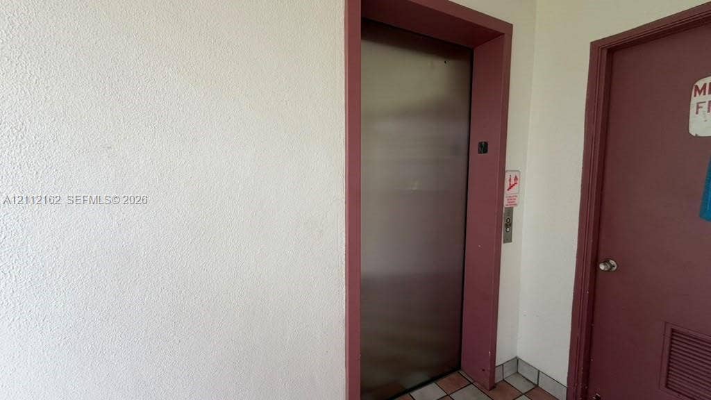 309 Fanshaw H, #309, Boca Raton, FL 33434 Stainless steel elevator doors featuring a metallic finish and a classic push-button control panel
