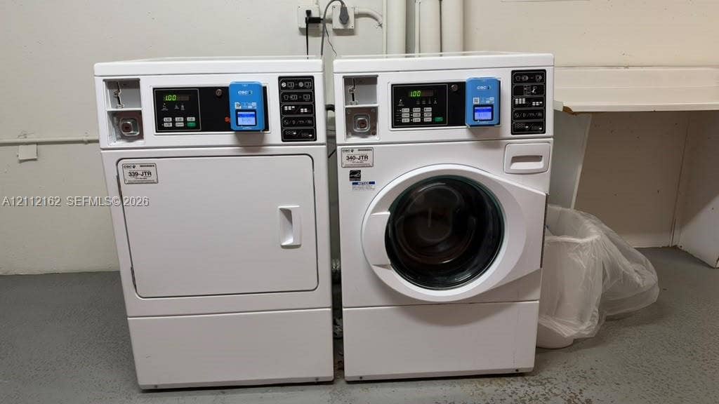 309 Fanshaw H, #309, Boca Raton, FL 33434 Commercial-grade laundry appliances featuring digital control panels, coin-operated mechanisms, and white finish