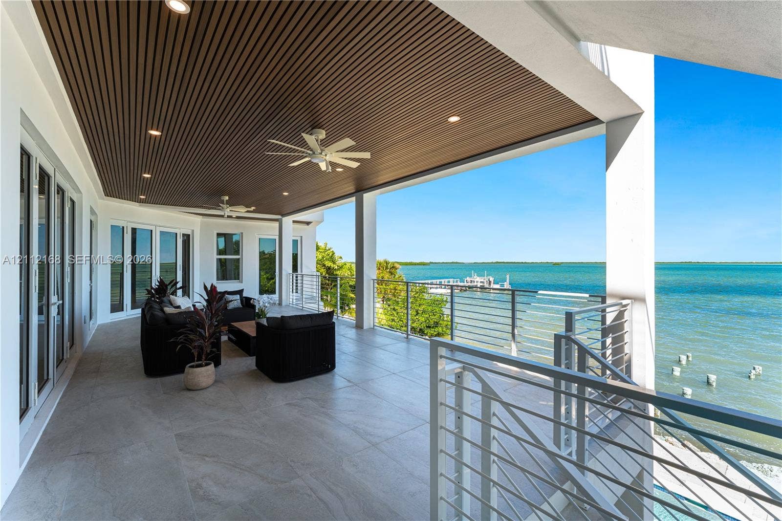 1041 E Buttonwood Drive, Sugarloaf Key, FL 33042 Covered terrace featuring large-format tile flooring, a slatted wood-finish ceiling, recessed lighting, ceiling fans, and a cable railing system