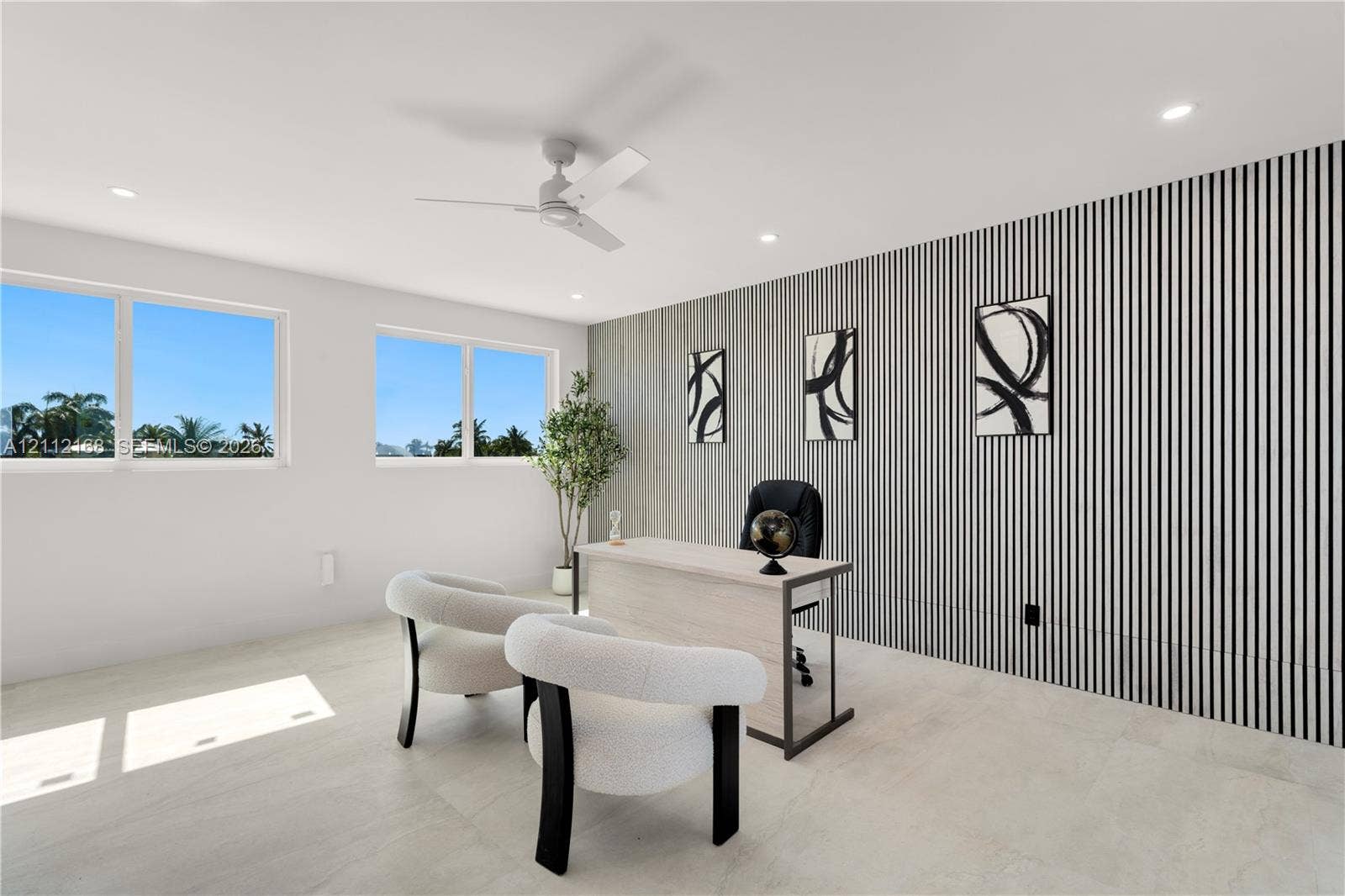 1041 E Buttonwood Drive, Sugarloaf Key, FL 33042 Room featuring large windows, neutral stone-finish flooring, recessed lighting, a modern ceiling fan, and a decorative vertical-slat accent wall