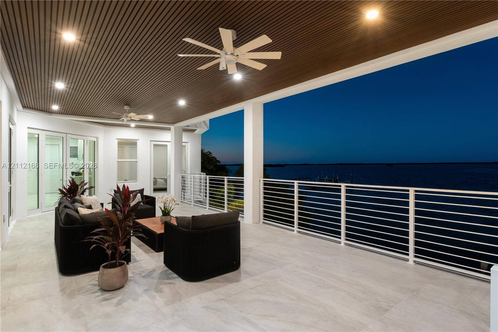 1041 E Buttonwood Drive, Sugarloaf Key, FL 33042 Covered terrace featuring large-format tile flooring, a slatted wood-finish ceiling with recessed lighting, dual ceiling fans, and a white horizontal rail system