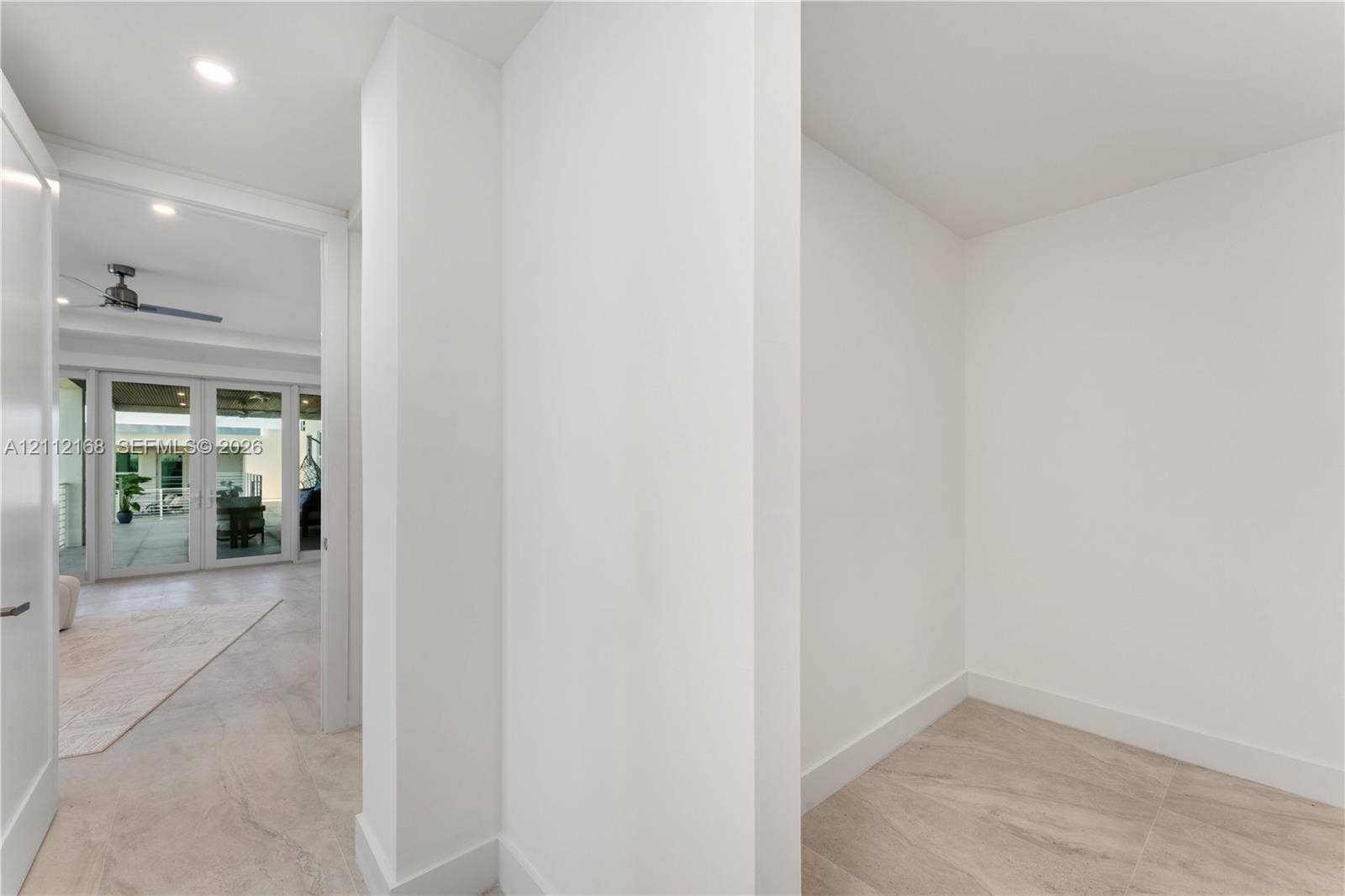 1041 E Buttonwood Drive, Sugarloaf Key, FL 33042 Neutral interior featuring smooth white wall finishes, recessed lighting, and stone-finish tile flooring