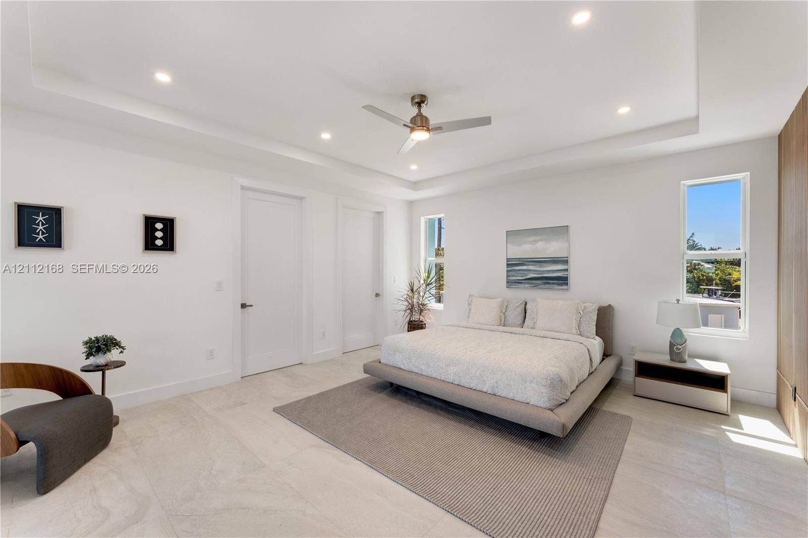 1041 E Buttonwood Drive, Sugarloaf Key, FL 33042 Tray ceiling featuring recessed lighting, a central ceiling fan, large-format tile flooring, and floor-to-ceiling wood-finish cabinetry