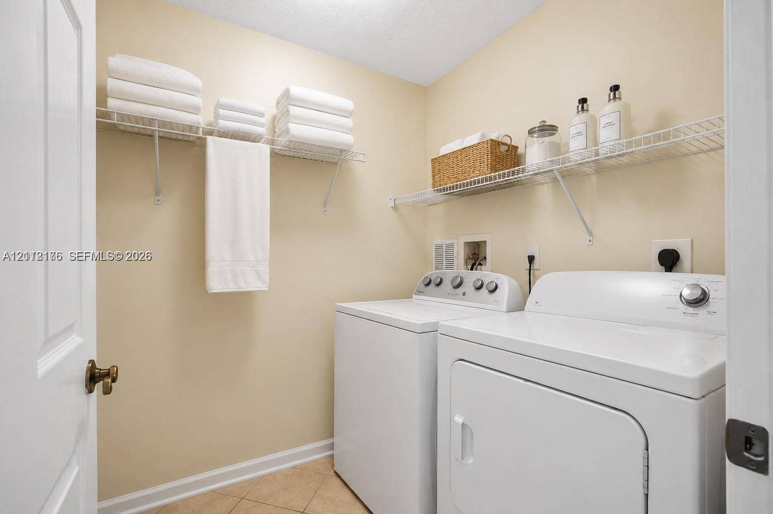 19143 Crystal Street, Weston, FL 33332 Laundry area featuring tile flooring and multi-level wire shelving