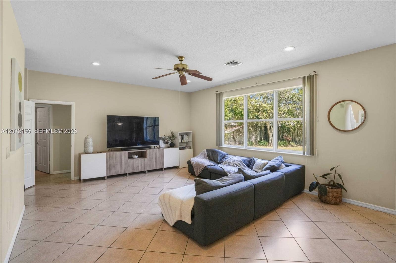 19143 Crystal Street, Weston, FL 33332 Living area featuring large format diagonal tile flooring, recessed lighting, a ceiling fan, and expansive windows
